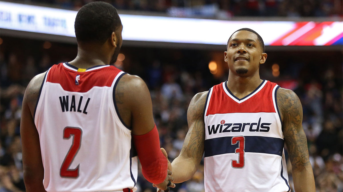 Washington Wizards guard Bradley Beal 3 celebrates with Wizards guard John Wall 2 in the final seconds against the Golden State Warriors in the fourth quarter at Verizon Center.jpg