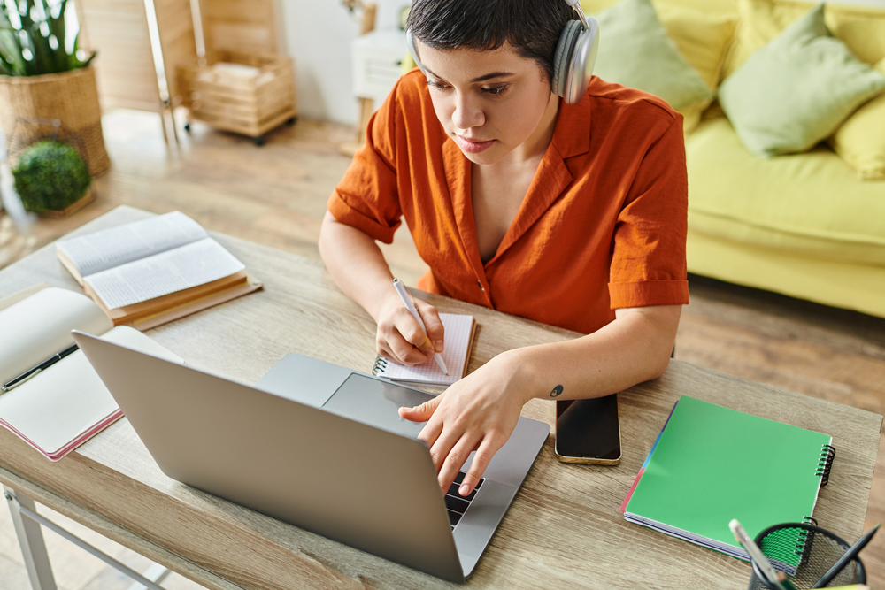 Attractive short haired woman with headphones doing transcription work from CrowdSurf.png