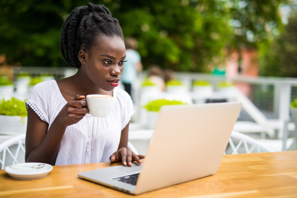 Black woman drinking coffee participating in a paid focus group online.png