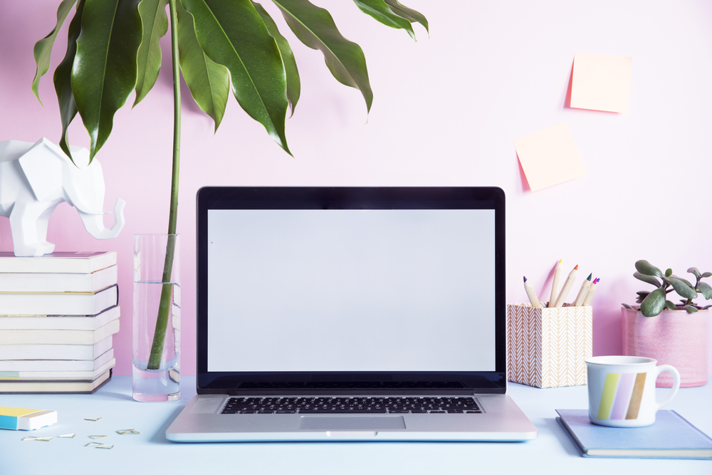 Modern workspace in pastel colors for blog post how to start a business with no money.png