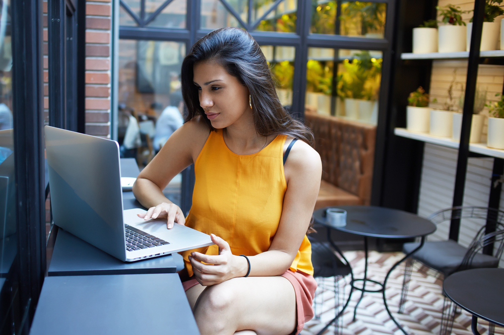 Young trendy woman searching for remote staffing agency jobs.png