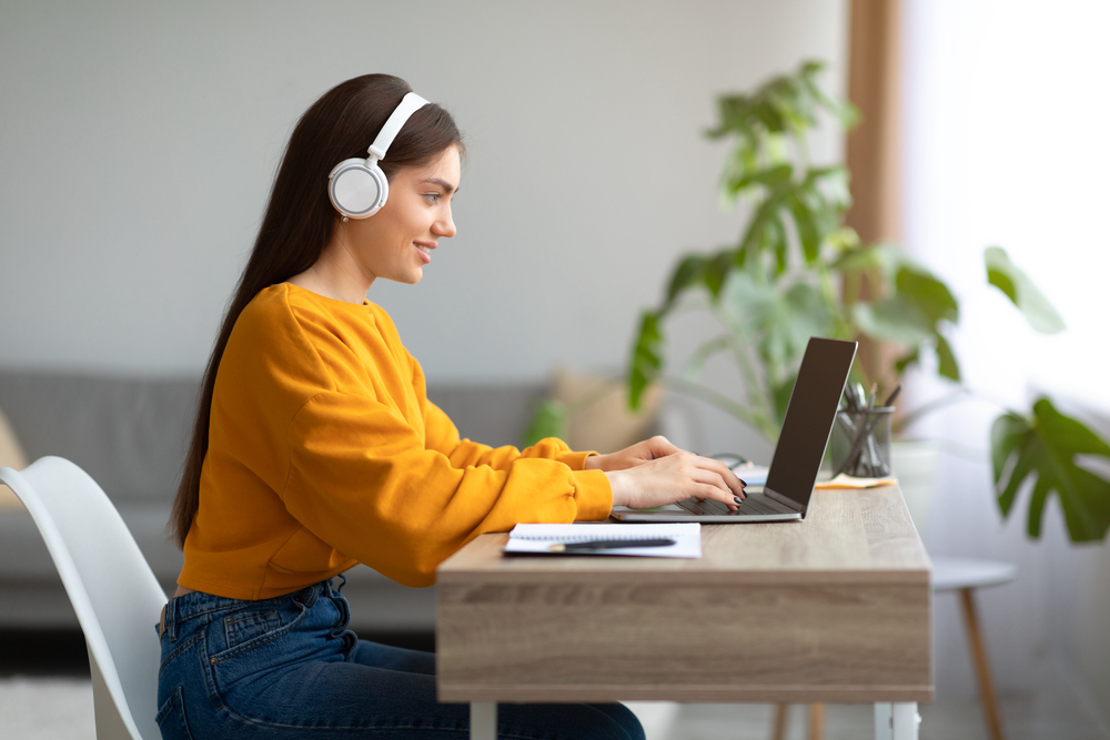 Young woman searching for legit transcription jobs online.png