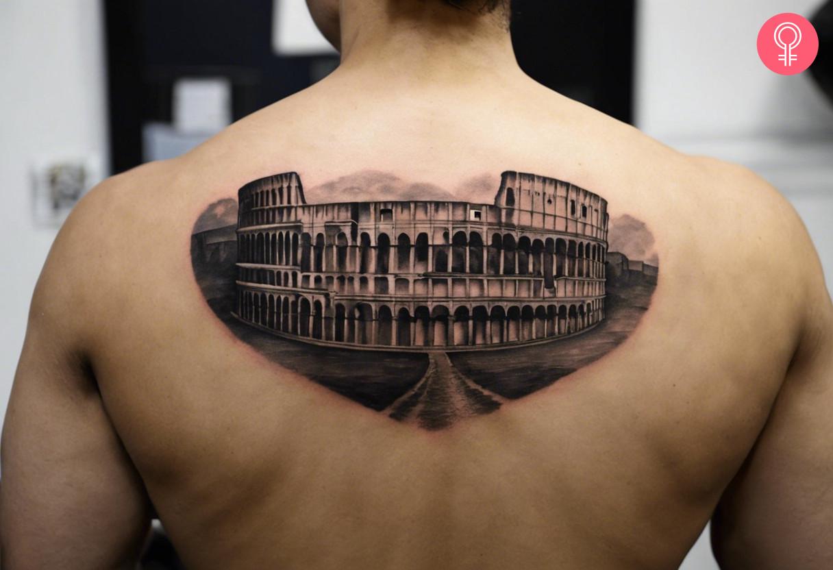 A Roman Colosseum tattoo on the upper back of a man.jpg