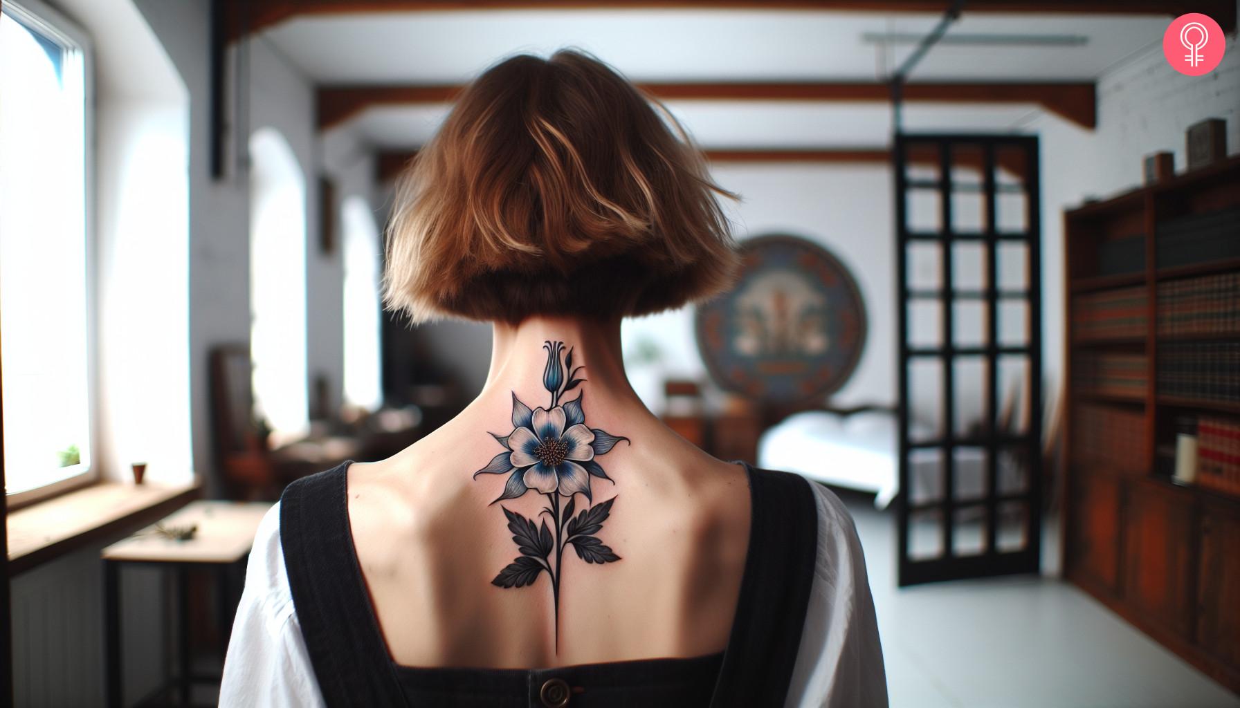 A beautiful blue columbine flower tattoo on the back.jpg