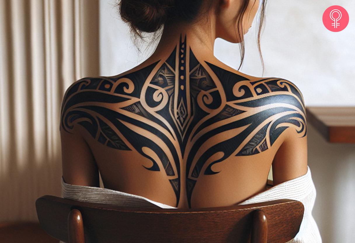 A bold black geometric design with swirls covering the upper back.jpg