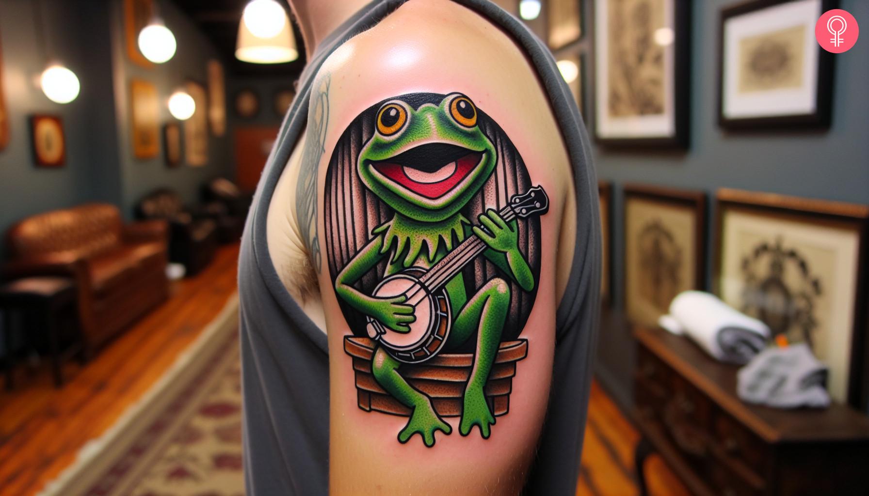 A colorful tattoo of a frog playing a banjo on the upper arm.jpg