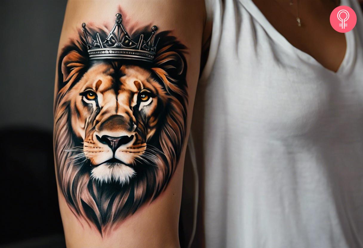 A realistic crowned lion head tattoo on the upper arm.jpg