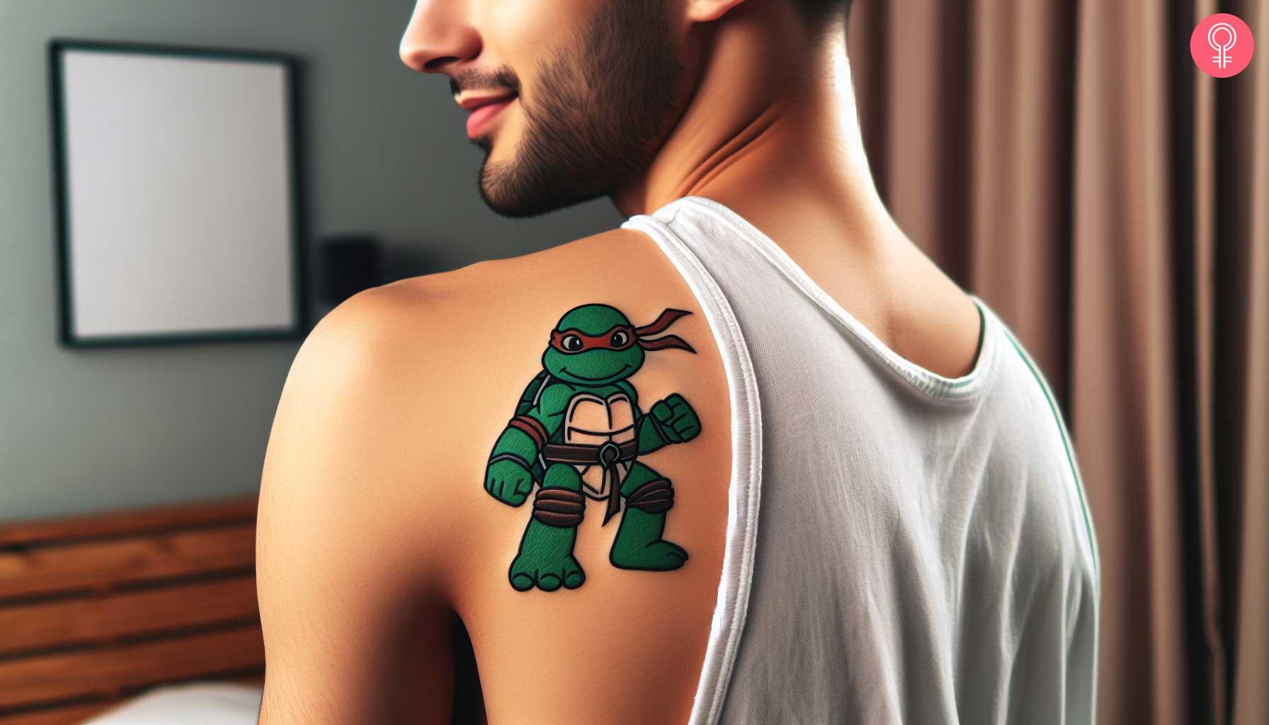A small baby ninja turtle tattoo on a mans shoulder.jpg