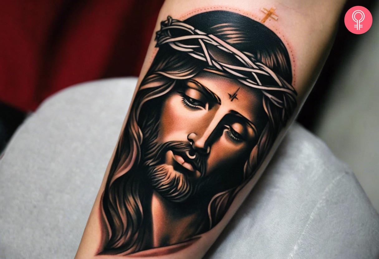 A traditional tattoo of a Jesus inked on forearm.jpg