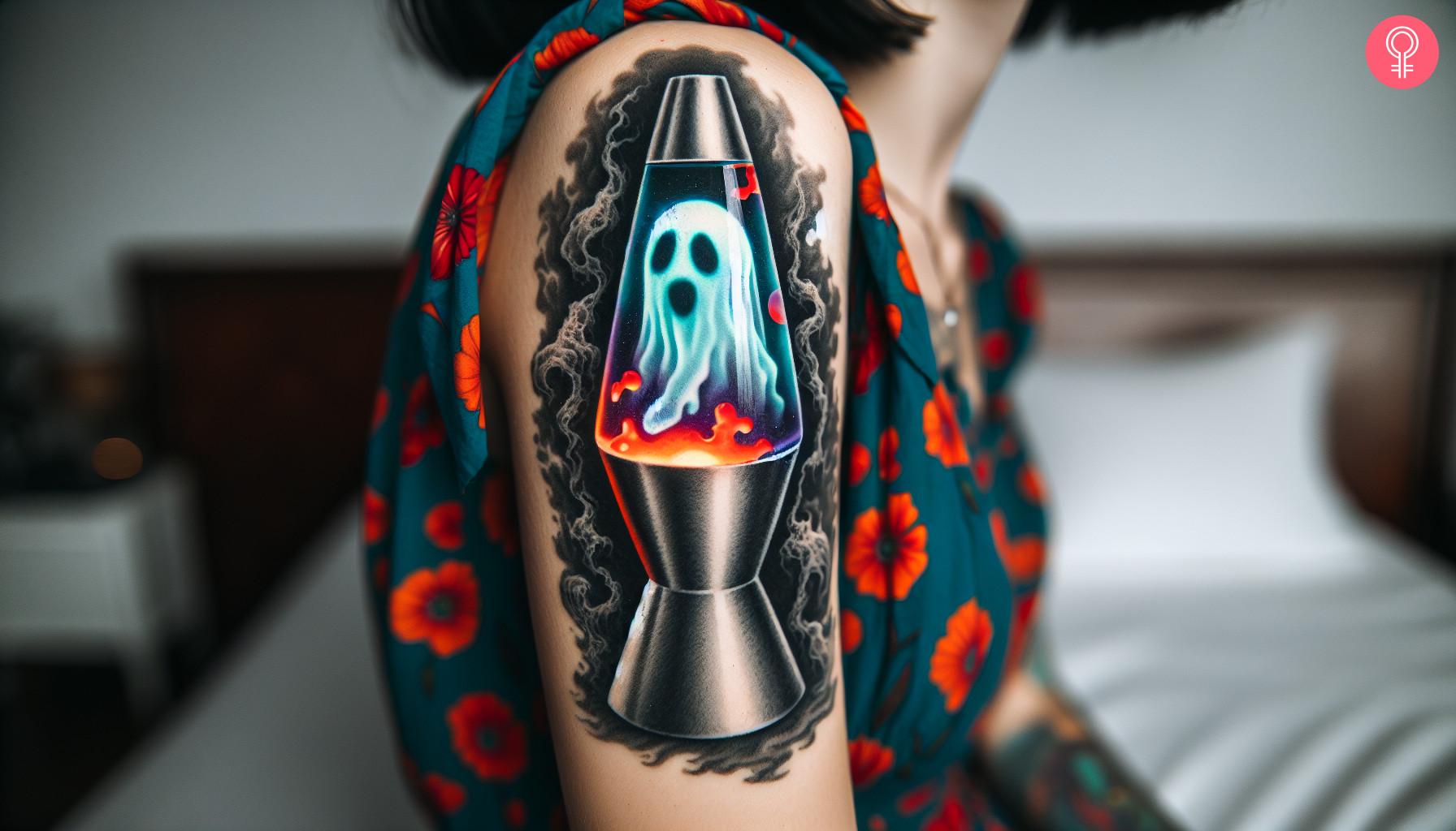 A woman with a colorful ghost lava lamp tattoo on her upper arm.jpg