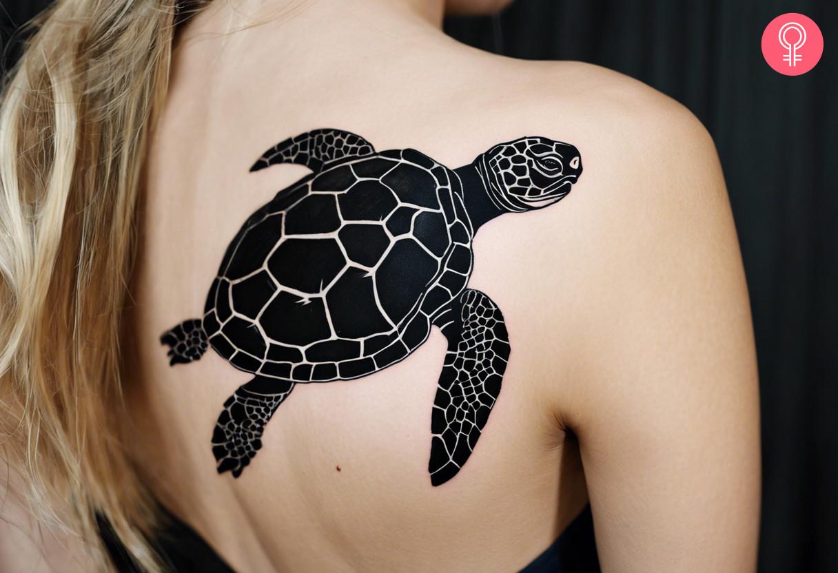 A woman with black tortoise tattoo on her upper back.jpg