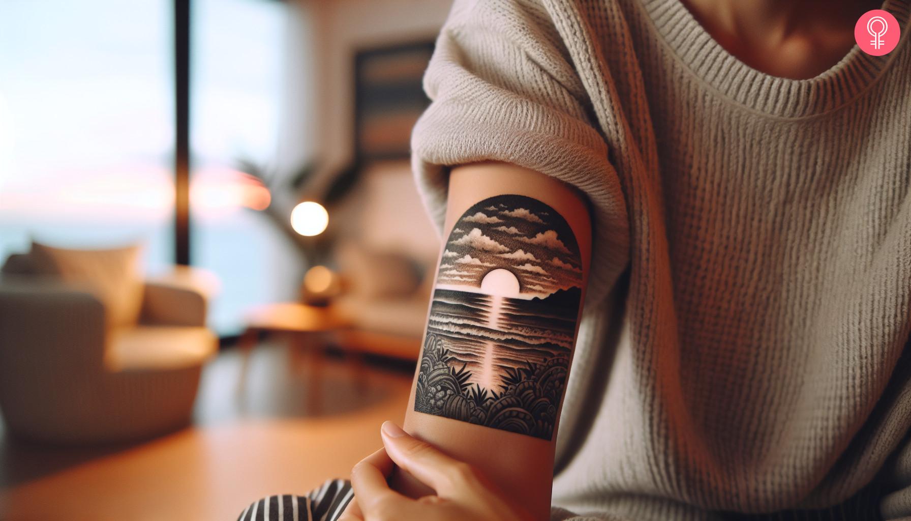 An upper arm black and white beach sunset tattoo.jpg