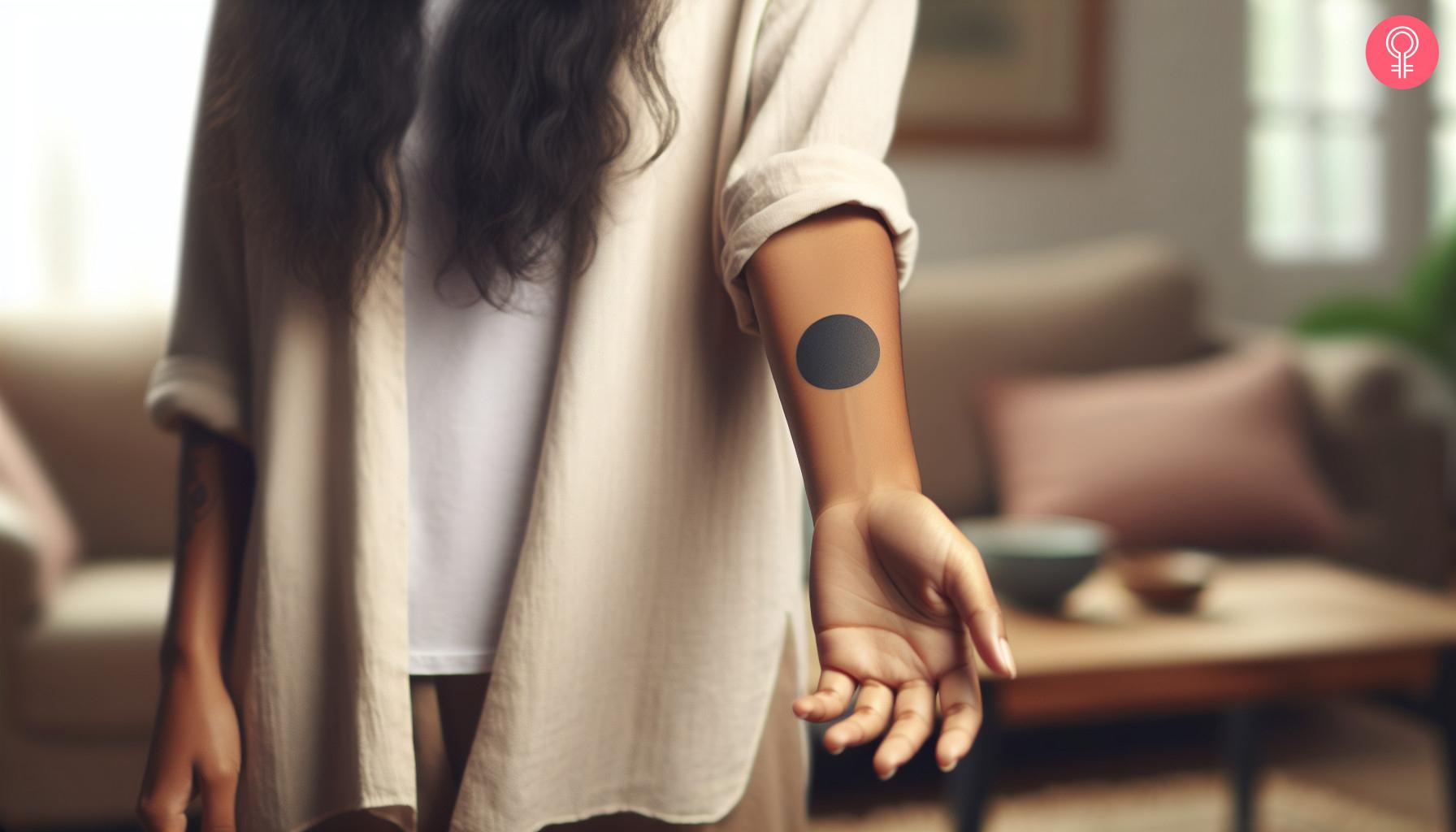 Black circle tattoo on the forearm.jpg