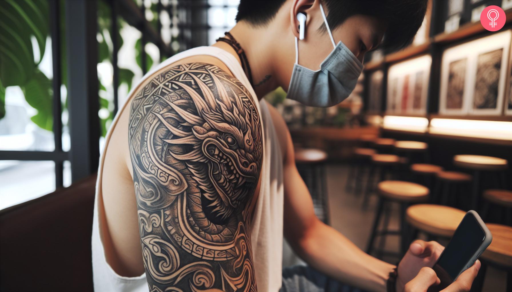 Tribal style Aztec serpent tattoo covering the shoulder and upper arm.jpg