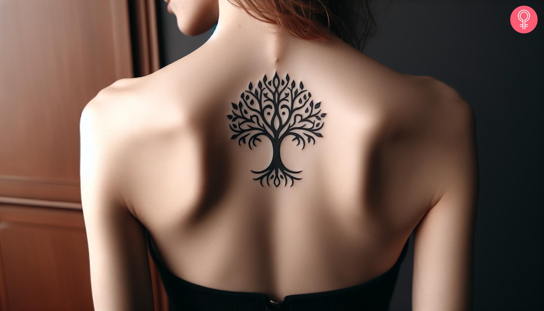 Woman with minimalist Lotr tattoo on her upper back.jpg