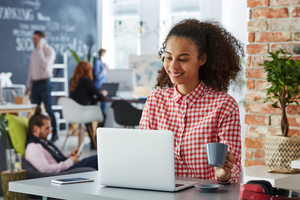 Woman working in a coworking space hoping to tap into her creativity.png