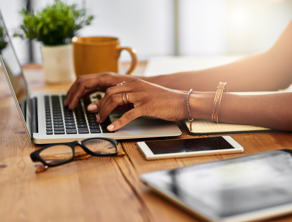 A female work from home data entry clerk working at home on her laptop.png