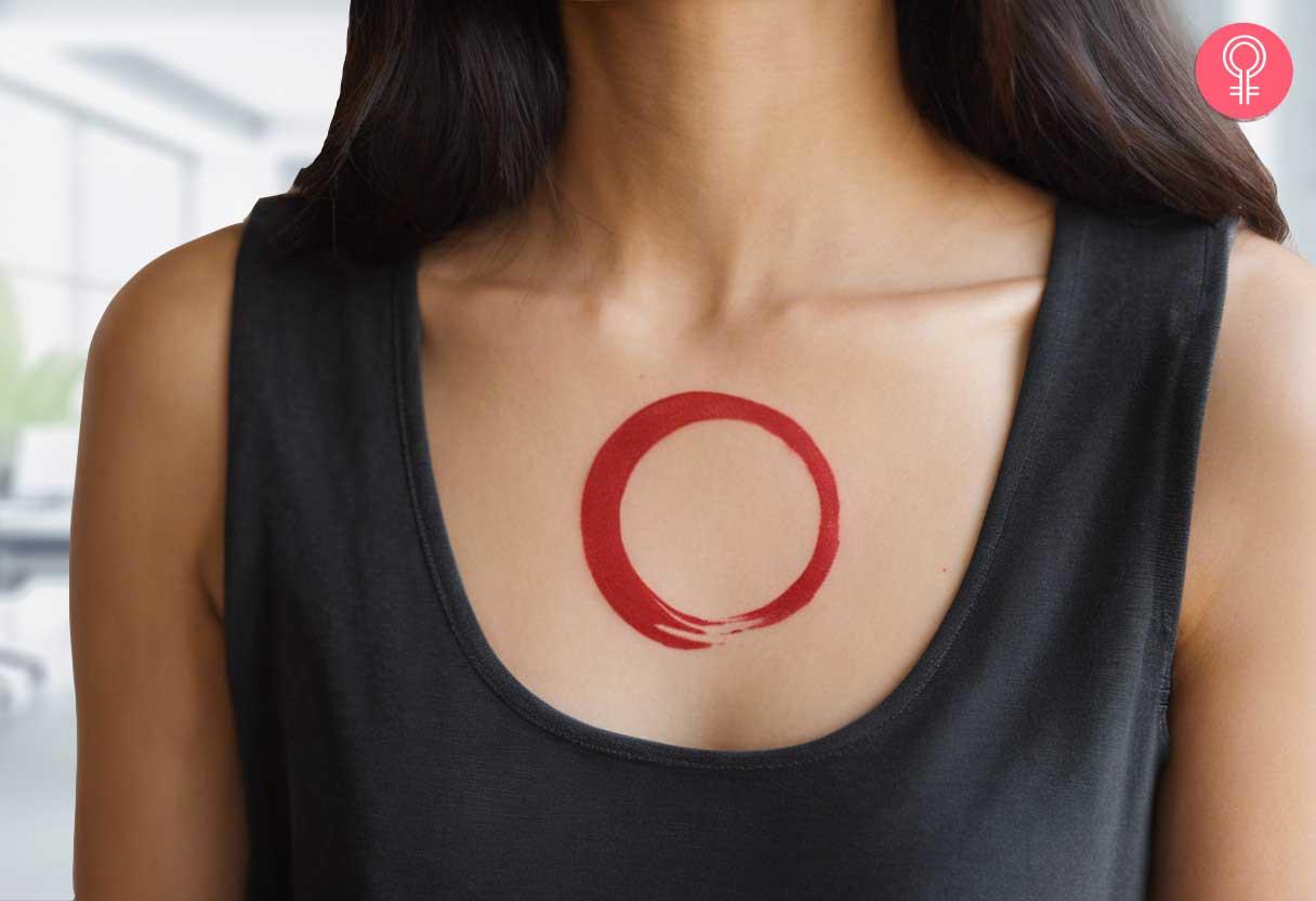 A minimalist enso tattoo on a womans chest.jpg