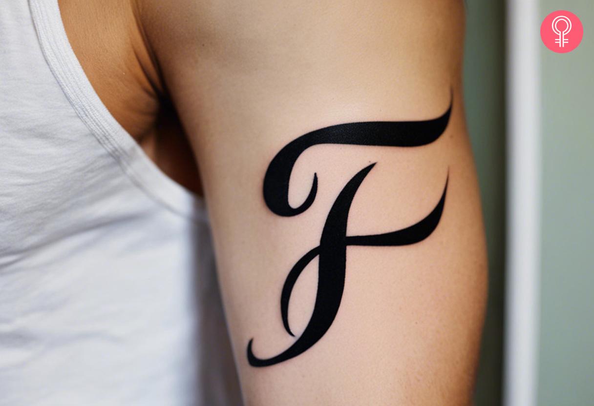 Calligraphy Letter F tattoo on the upper arm.jpg