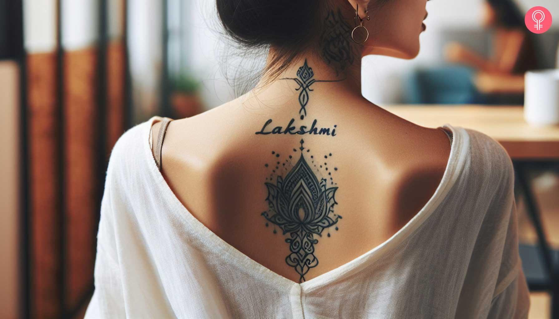 Lakshmi name tattoo on the upper back.jpg