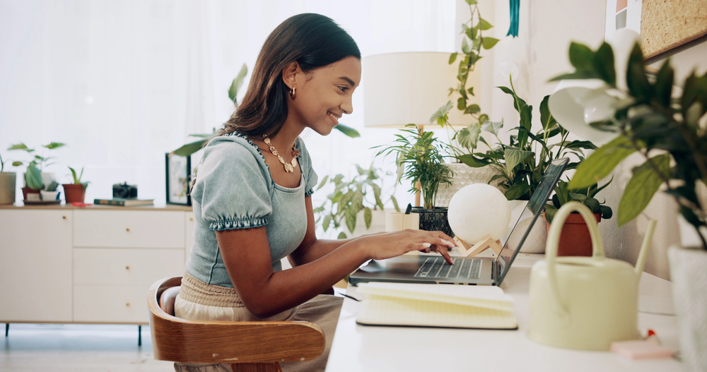 A young woman searching for W 2 work from home jobs on her laptop 1.jpeg